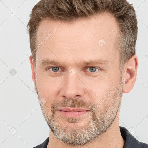 Joyful white adult male with short  brown hair and grey eyes