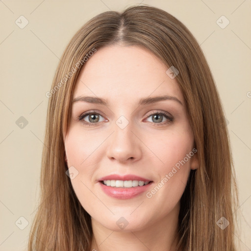 Joyful white young-adult female with long  brown hair and green eyes