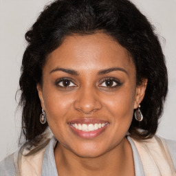 Joyful black young-adult female with medium  brown hair and brown eyes