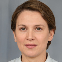 Joyful white adult female with short  brown hair and grey eyes