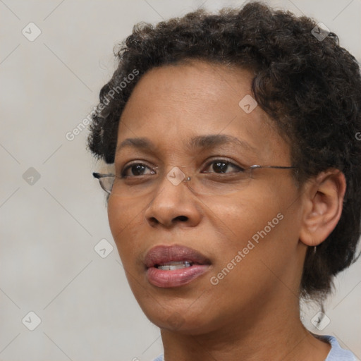 Joyful black adult female with short  brown hair and brown eyes