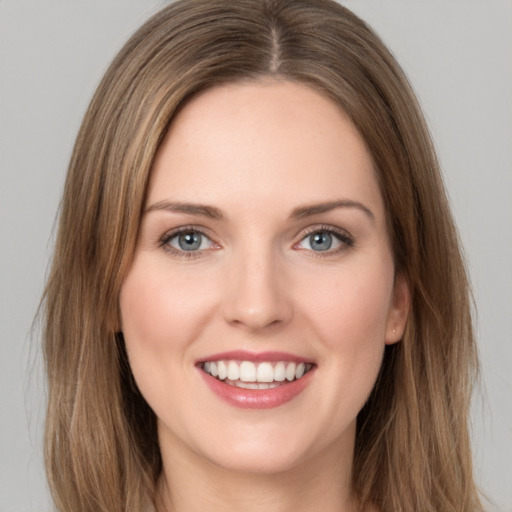 Joyful white young-adult female with long  brown hair and green eyes