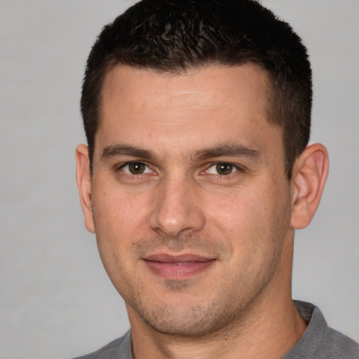 Joyful white young-adult male with short  brown hair and brown eyes