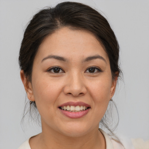 Joyful asian young-adult female with medium  brown hair and brown eyes