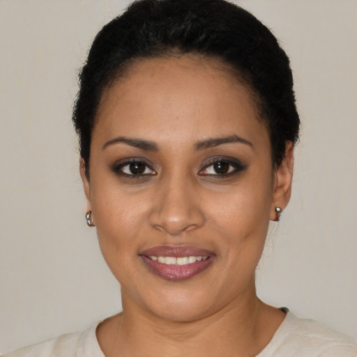 Joyful latino young-adult female with short  black hair and brown eyes