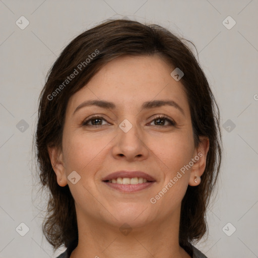 Joyful white adult female with medium  brown hair and brown eyes