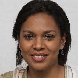 Joyful black young-adult female with medium  brown hair and brown eyes