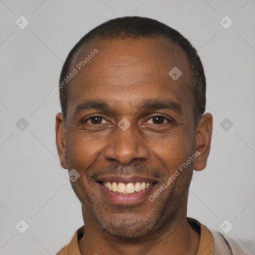 Joyful black adult male with short  black hair and brown eyes