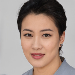 Joyful asian young-adult female with short  black hair and brown eyes