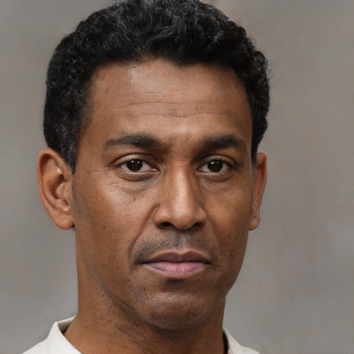 Neutral latino adult male with short  brown hair and brown eyes
