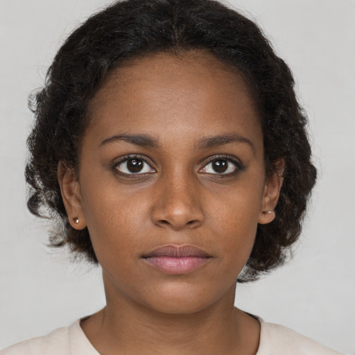 Neutral black young-adult female with medium  brown hair and brown eyes