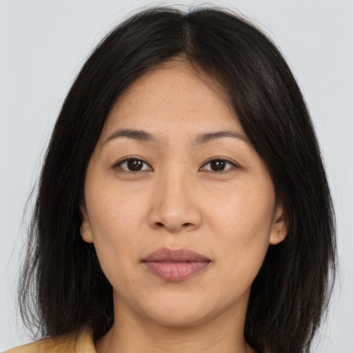 Joyful asian young-adult female with long  brown hair and brown eyes