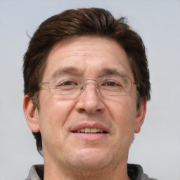 Joyful white adult male with short  brown hair and grey eyes