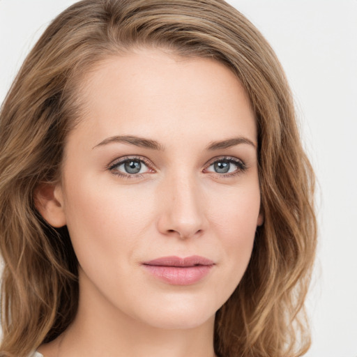 Joyful white young-adult female with long  brown hair and green eyes