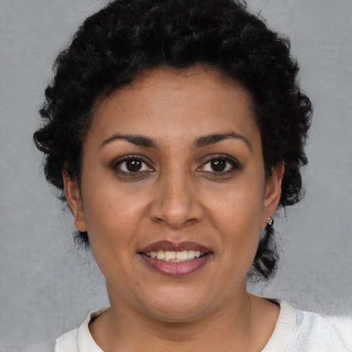 Joyful latino young-adult female with short  brown hair and brown eyes