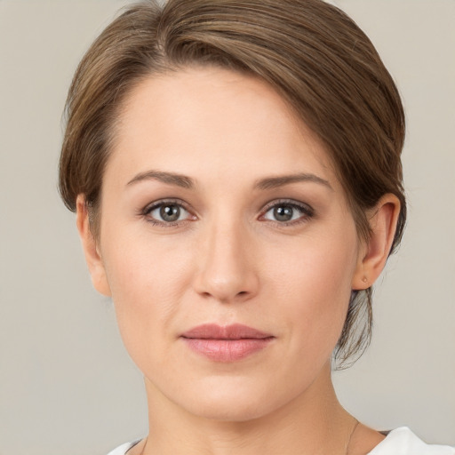 Joyful white young-adult female with medium  brown hair and grey eyes