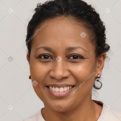 Joyful black adult female with short  brown hair and brown eyes