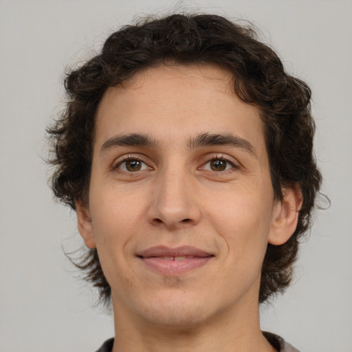 Joyful white young-adult male with medium  brown hair and brown eyes