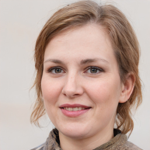 Joyful white young-adult female with medium  brown hair and blue eyes