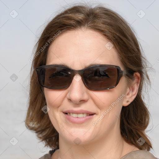 Joyful white young-adult female with medium  brown hair and blue eyes