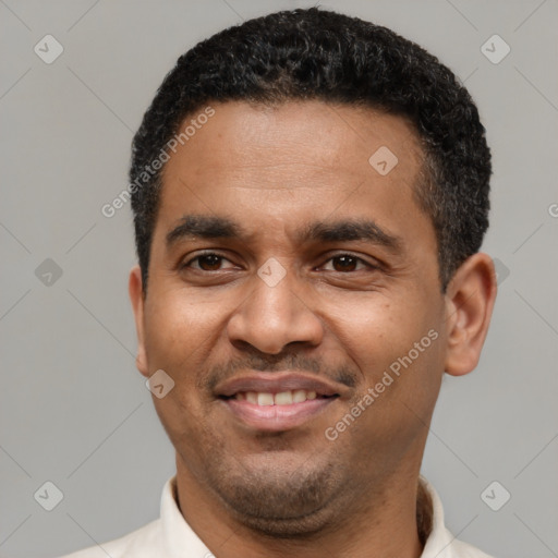 Joyful latino young-adult male with short  black hair and brown eyes