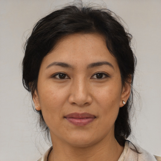 Joyful asian adult female with medium  brown hair and brown eyes