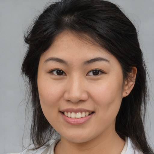Joyful asian young-adult female with medium  brown hair and brown eyes
