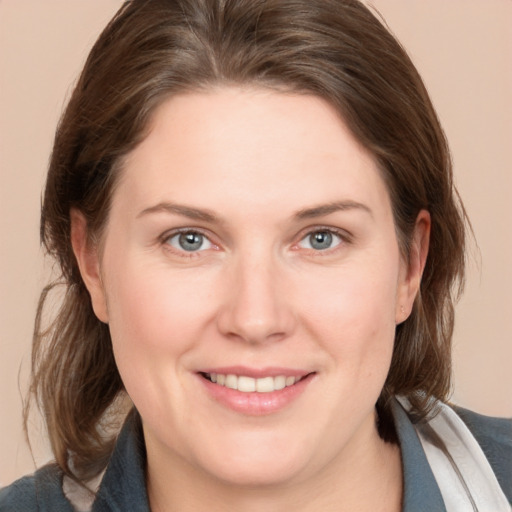 Joyful white young-adult female with medium  brown hair and grey eyes