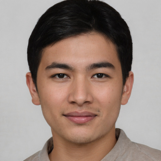 Joyful asian young-adult male with short  brown hair and brown eyes