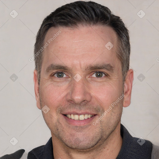 Joyful white adult male with short  brown hair and brown eyes