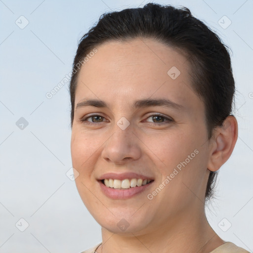 Joyful white young-adult female with short  brown hair and brown eyes