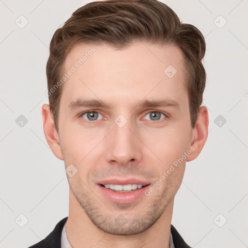 Joyful white young-adult male with short  brown hair and grey eyes