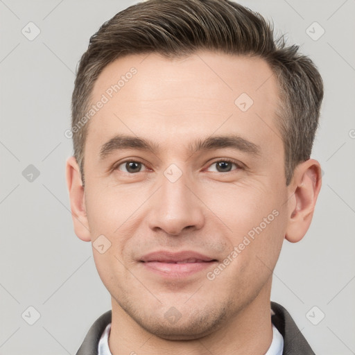 Joyful white young-adult male with short  brown hair and brown eyes