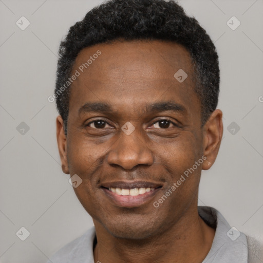 Joyful black adult male with short  black hair and brown eyes