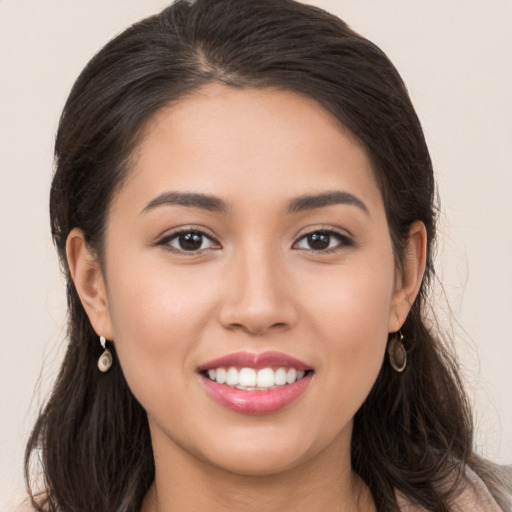 Joyful white young-adult female with long  brown hair and brown eyes