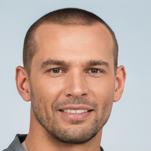 Joyful white young-adult male with short  brown hair and brown eyes