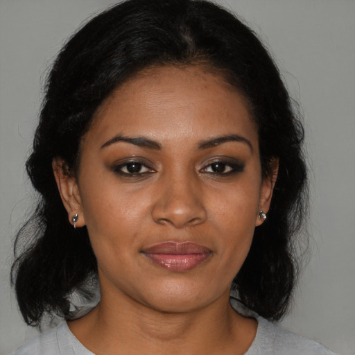 Joyful black young-adult female with medium  black hair and brown eyes