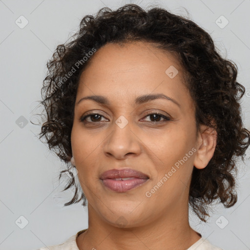 Joyful latino adult female with medium  brown hair and brown eyes