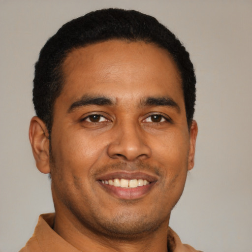 Joyful latino young-adult male with short  black hair and brown eyes