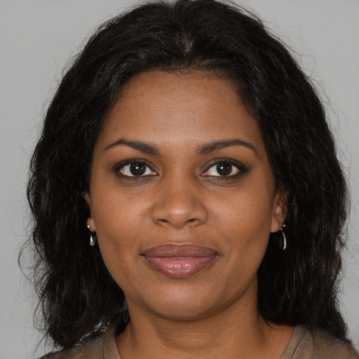 Joyful black young-adult female with medium  black hair and brown eyes
