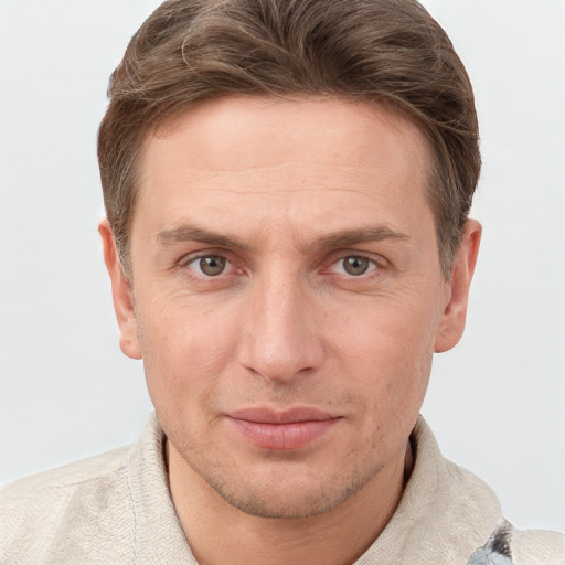 Joyful white adult male with short  brown hair and grey eyes