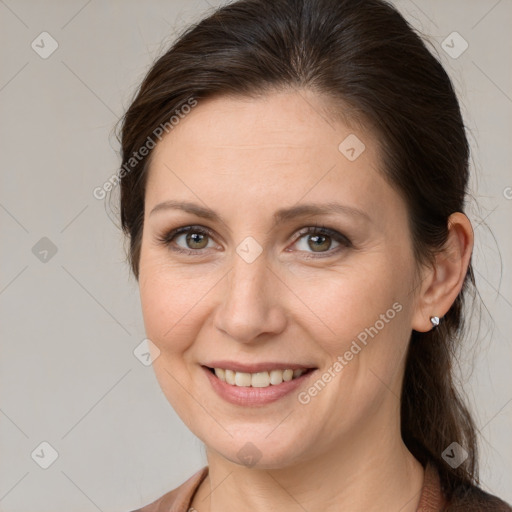 Joyful white adult female with medium  brown hair and grey eyes