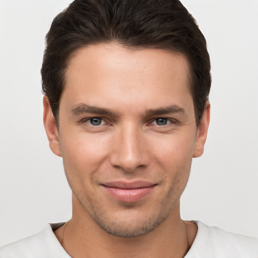 Joyful white young-adult male with short  brown hair and brown eyes