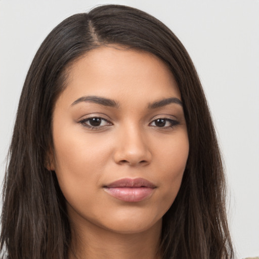 Joyful latino young-adult female with long  brown hair and brown eyes