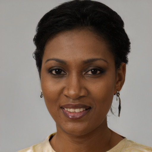 Joyful black young-adult female with short  black hair and brown eyes