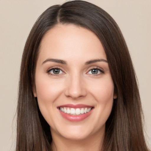 Joyful white young-adult female with long  brown hair and brown eyes