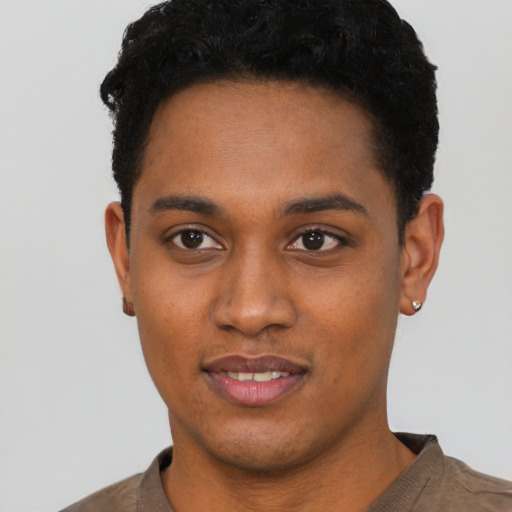 Joyful black young-adult male with short  black hair and brown eyes