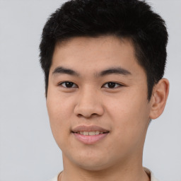 Joyful asian young-adult male with short  brown hair and brown eyes