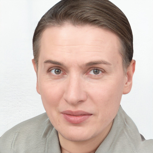 Joyful white adult female with short  brown hair and blue eyes