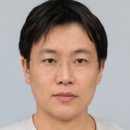 Neutral asian adult male with short  brown hair and brown eyes